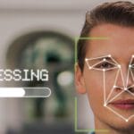 A man outdoors with facial recognition graphics and a processing bar overlayed on his face.