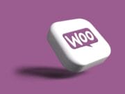 A white 3D square button with a purple Woo speech bubble logo, floating above a purple background.