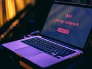 Open laptop displaying a proxy network screen with a Connect button, set against a background with soft yellow lighting.