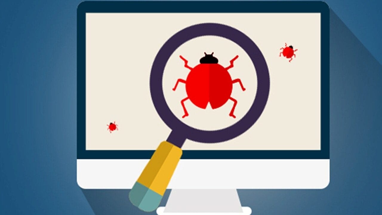A computer monitor displays a magnifying glass focusing on a red bug, symbolizing software bug detection.
