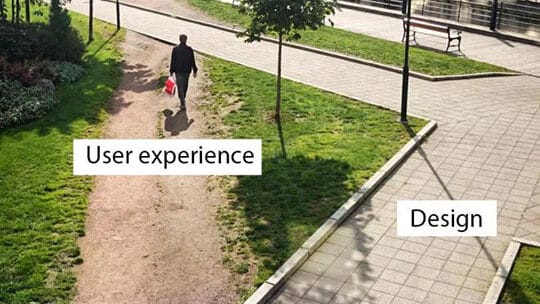 A person walks on a dirt path labeled User experience instead of the paved path labeled Design in a park.