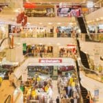 a mall filled with lots of people and escalators