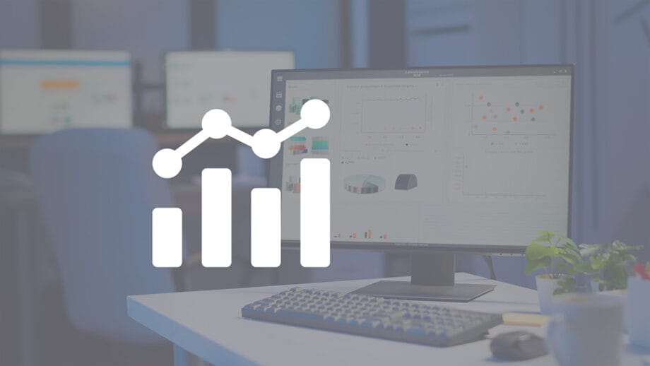 A computer monitor displaying data charts and graphs on a desk, overlaid with a white bar and line graph icon.