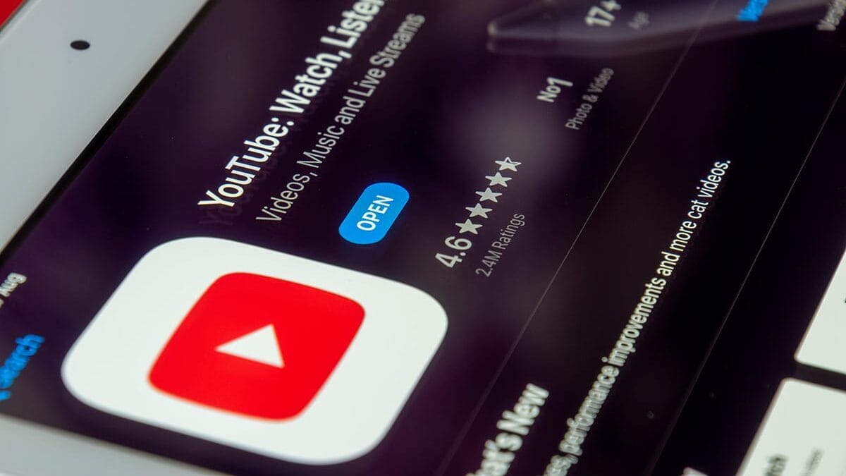 Close-up of a tablet screen displaying the YouTube app page in an app store, showing ratings and an Open button.