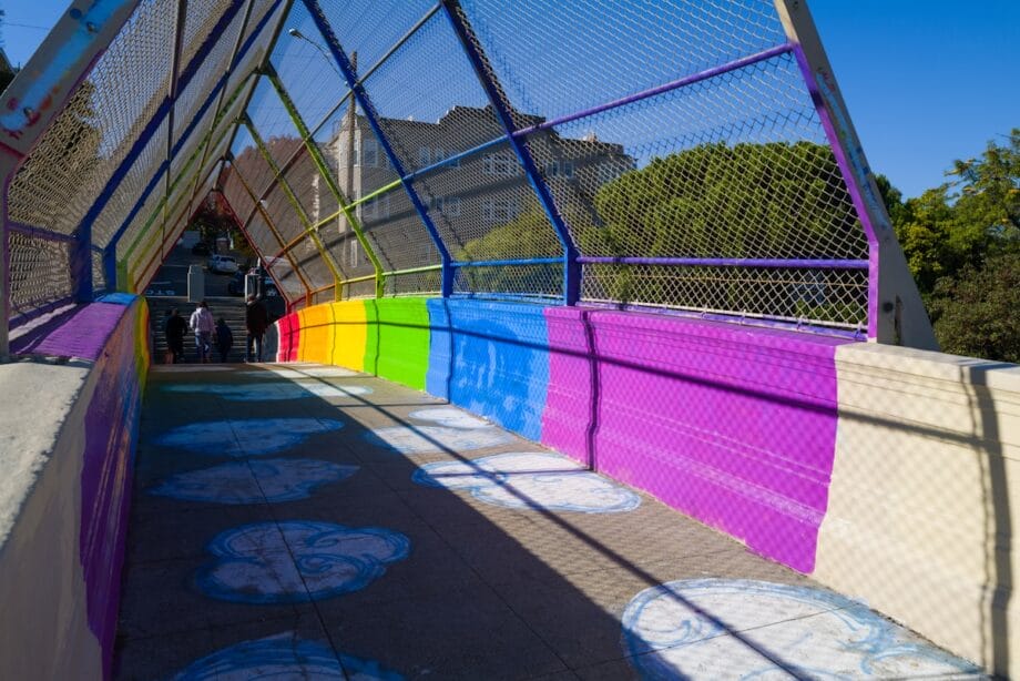 a colorful walkway with a train going over it
