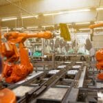 a factory filled with lots of orange machines
