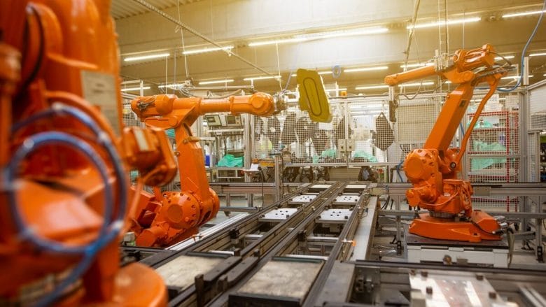 a factory filled with lots of orange machines