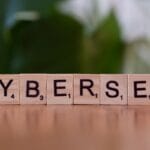 A wooden block spelling cybersec on a table