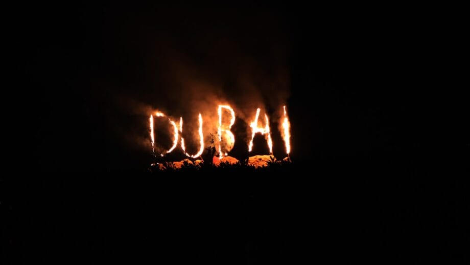 A blurry photo of the word dubai lit up in the dark