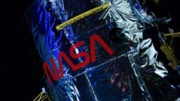 Close-up of a NASA spacecraft or satellite covered in reflective material with the NASA logo visible.