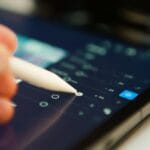 Someone is editing with a stylus on a tablet.