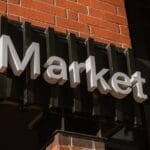 a sign on the side of a building that says market