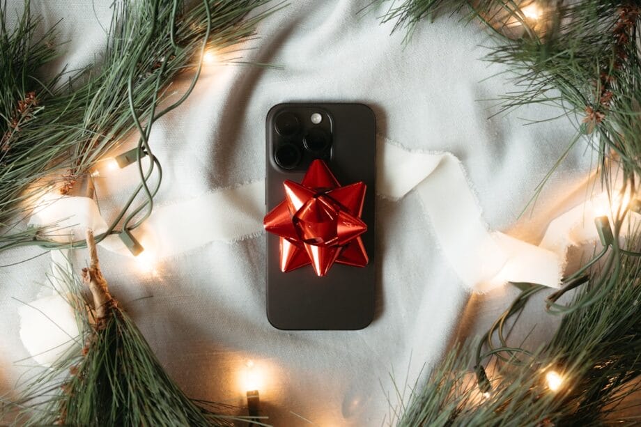 A cell phone with a red bow on it