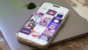 A cell phone sitting on top of a laptop computer