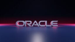 The word ORACLE in bold, 3D letters is displayed on a reflective surface with a dark gradient background.