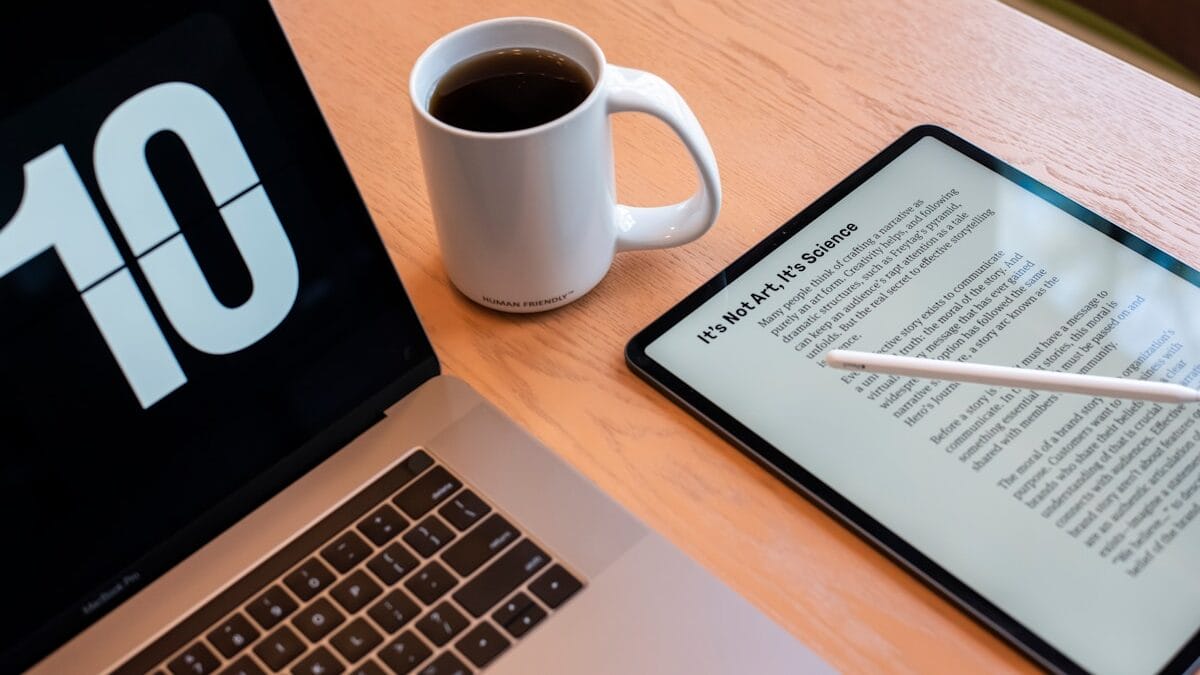 a tablet and a cup of coffee on a table