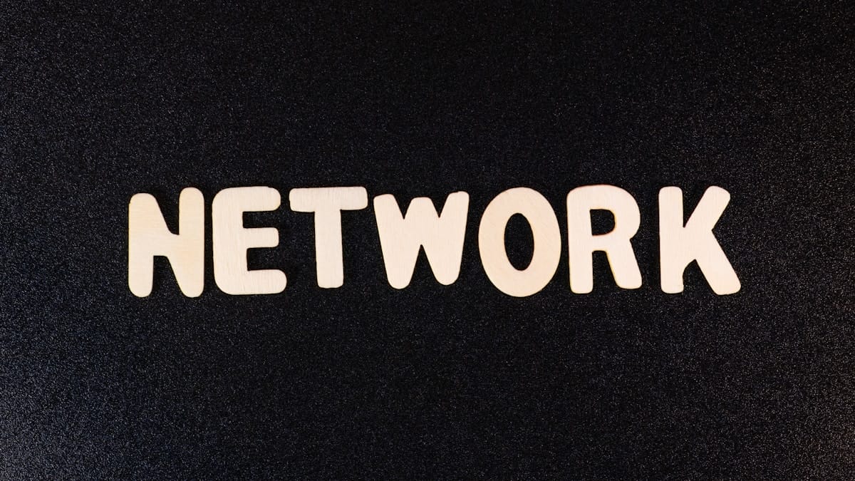 The word NETWORK spelled out in large, white letters on a black textured background.