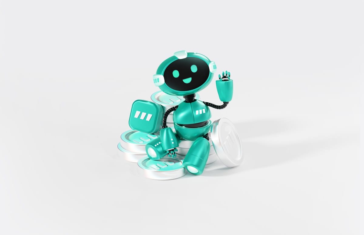 A turquoise and black robot sits on stacked coins, waving with a friendly expression against a white background.