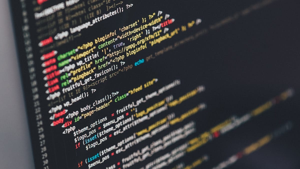 Computer monitor displaying code with various colored syntax highlighting on a dark background.