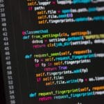 Close-up of a computer screen displaying Python code with functions and syntax highlighted in various colors.
