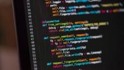 Close-up of a computer screen displaying Python code with functions and syntax highlighted in various colors.
