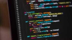 Close-up of a computer screen displaying Python code with functions and syntax highlighted in various colors.