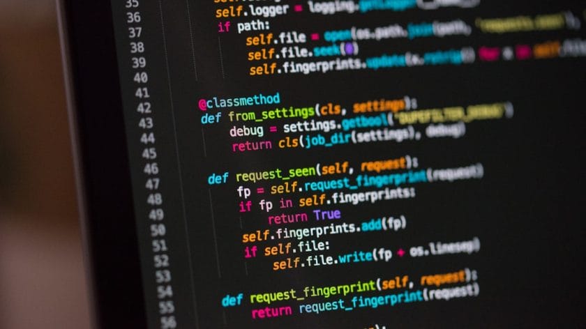 Close-up of a computer screen displaying Python code with functions and syntax highlighted in various colors.