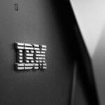 Close-up of the metallic IBM logo on the side of a black server or computer hardware unit.