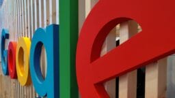 Close-up of colorful 3D letters spelling Google mounted on a vertical wooden slat wall.