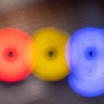 Blurred image of the Google logo with indistinct, colorful letters on a dark background.