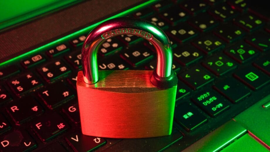 A padlock placed on a laptop keyboard, symbolizing cybersecurity or data protection.