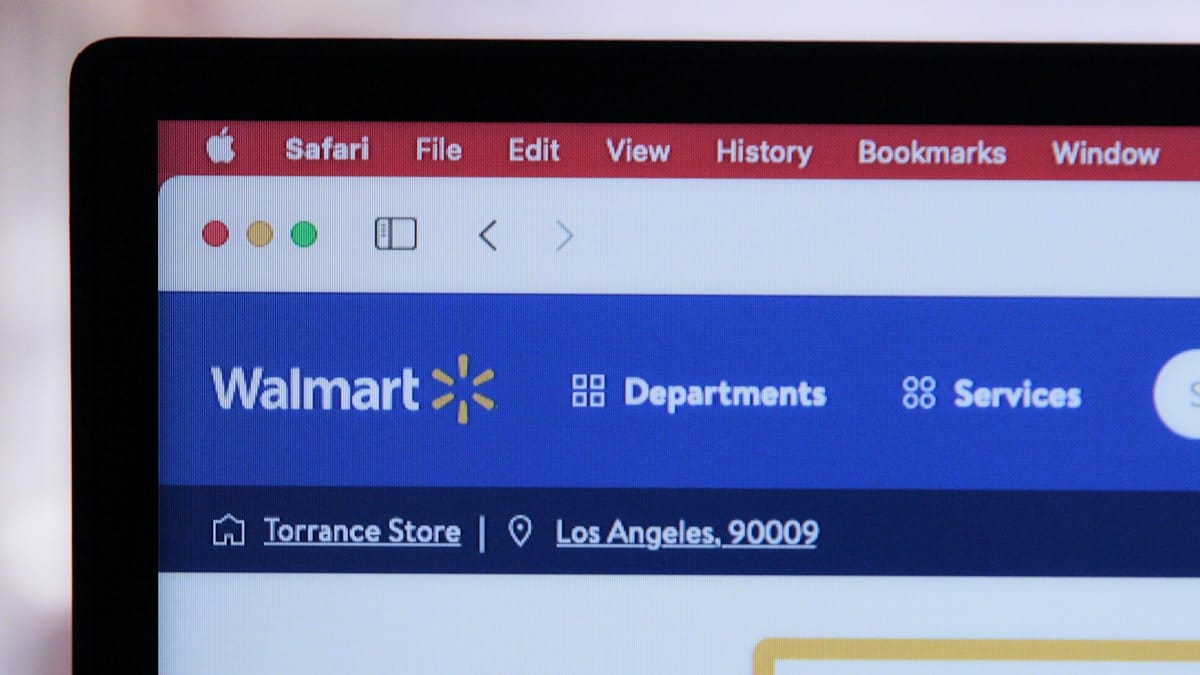 A computer screen shows the Walmart website open in Safari, with a Torrance, Los Angeles store location displayed.