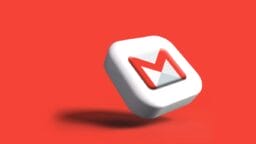 A 3D Gmail logo icon floats against a solid red background, casting a shadow below it.