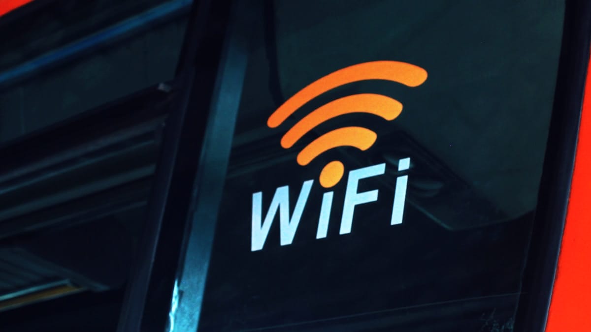 A window with an orange WiFi symbol and the word WiFi printed on it, likely indicating wireless internet availability.