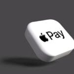 A white square with the Apple Pay logo on it, floating against a plain gray background.