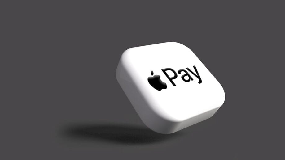 A white square with the Apple Pay logo on it, floating against a plain gray background.