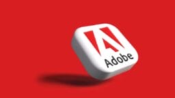 A 3D square with the Adobe logo and text on a red background, casting a shadow to the left.