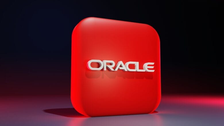 A red rounded square with the word ORACLE in white 3D letters on the front, set against a dark gradient background.