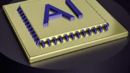 A gold computer chip with the large blue letters AI on its surface, symbolizing artificial intelligence technology.
