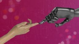 A human hand and a robotic hand reach toward each other with fingers almost touching, against a pink circuit-patterned background.