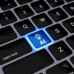 A computer keyboard with a glowing blue key labeled AI featuring a robot icon, replacing the usual letter key between Q and W.