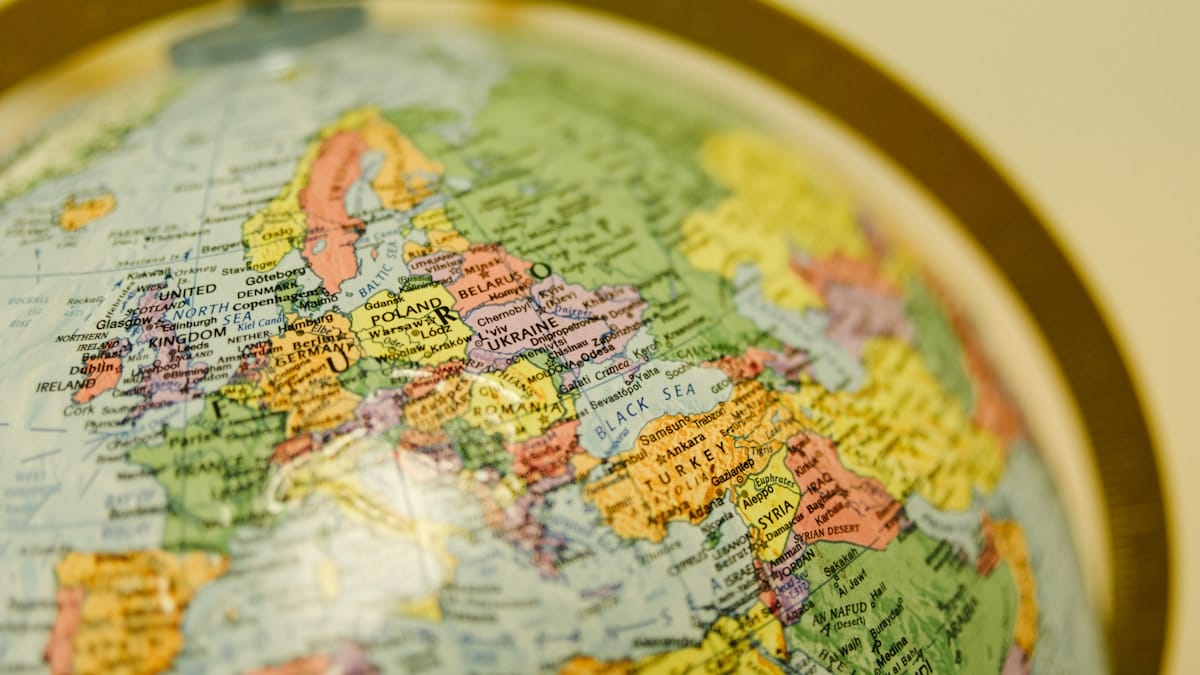 Close-up of a globe focused on Europe, showing countries including Poland, Ukraine, Germany, Italy, and surrounding regions.