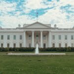 The white house stands under a bright sky.