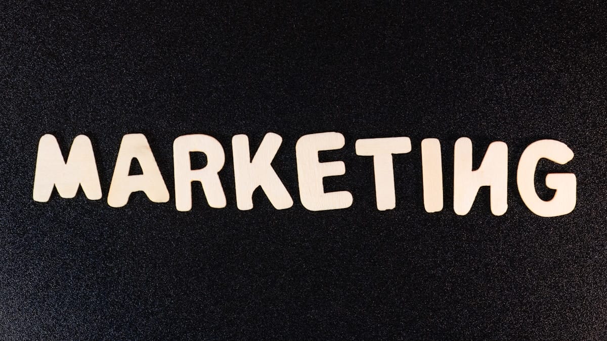 The word MARKETING spelled out in large, light-colored letters on a textured black background.