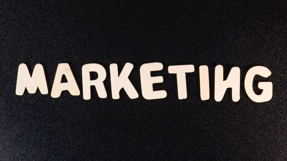 The word MARKETING spelled out in bold, white letters on a textured black background.