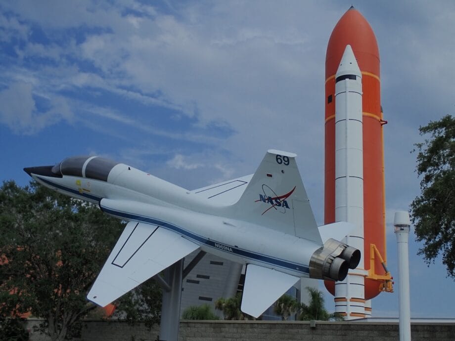 a model of a fighter jet next to a rocket