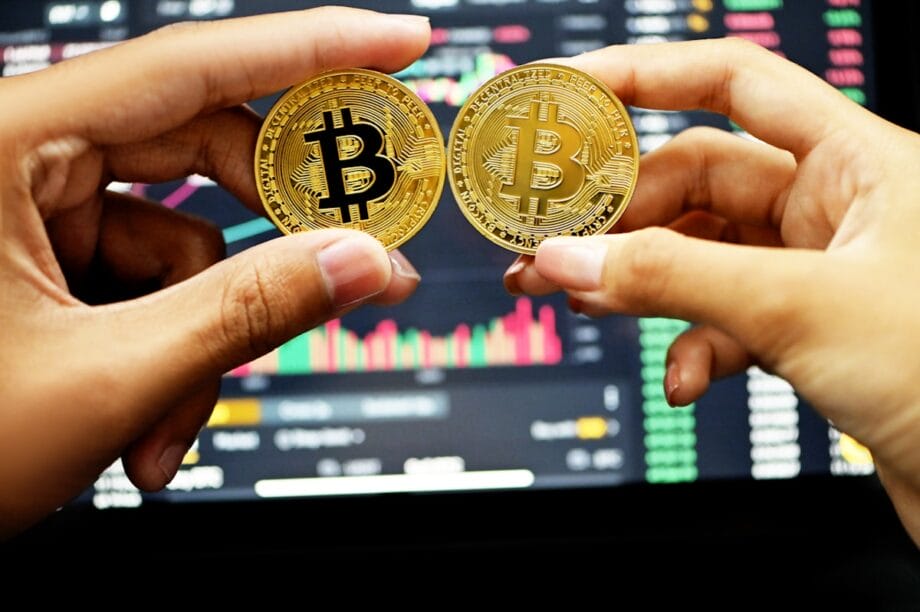 gold round coin on persons hand