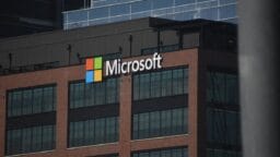 A tall building with a microsoft logo on top of it