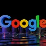 The Google logo in colorful 3D letters stands on a reflective, futuristic surface with black and rainbow light reflections.