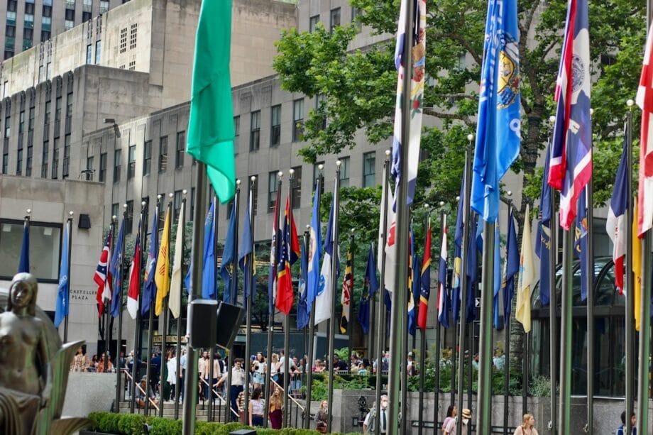 a group of flags in front of a building